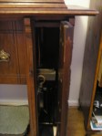 Treadle mechanism hidden behind mock drawers on the right